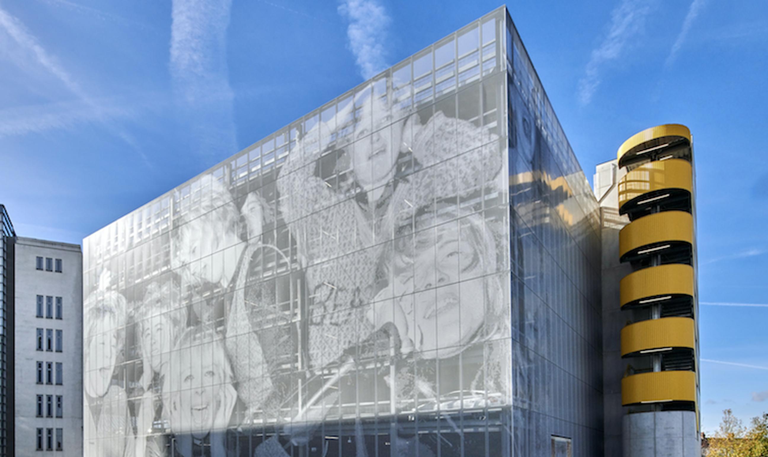 Studio Egret West designed a façade for The Music Box at The Old Vinyl Factory that uses an image of Beatles fans in a nod to site’s former life as a record factory