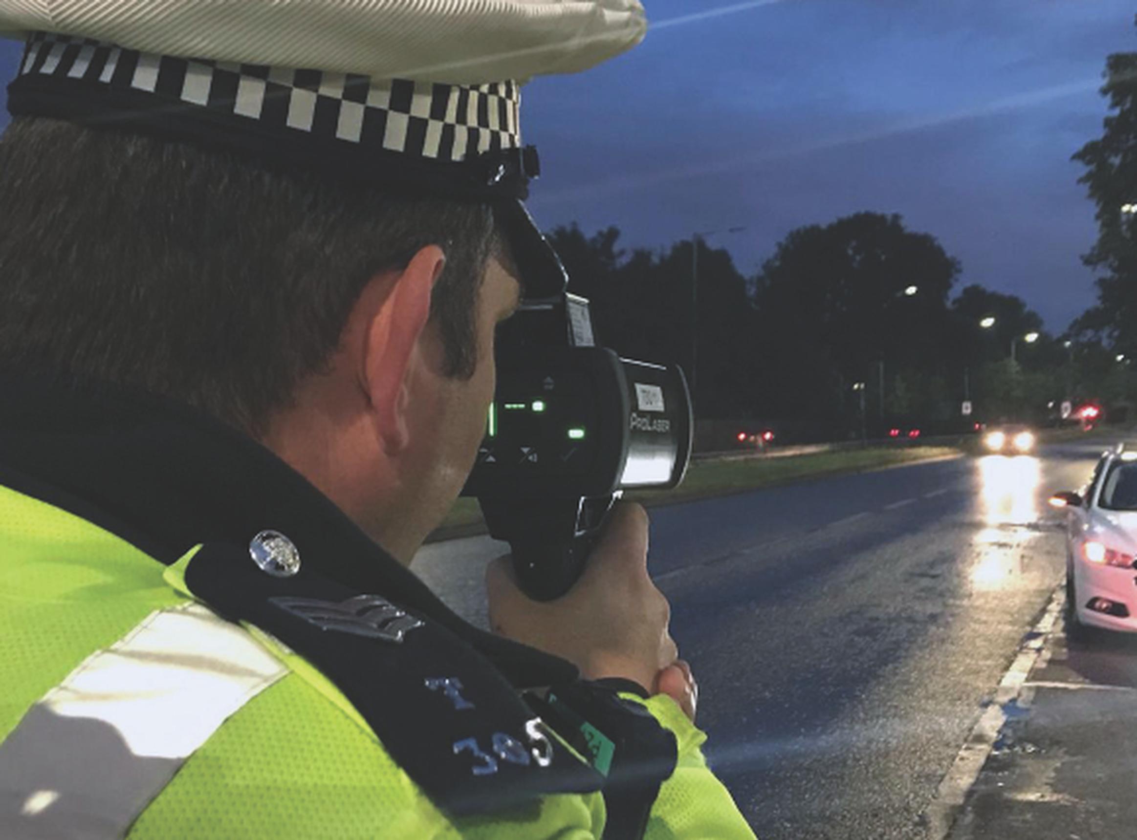 A Met police officer checking speeds on the A10