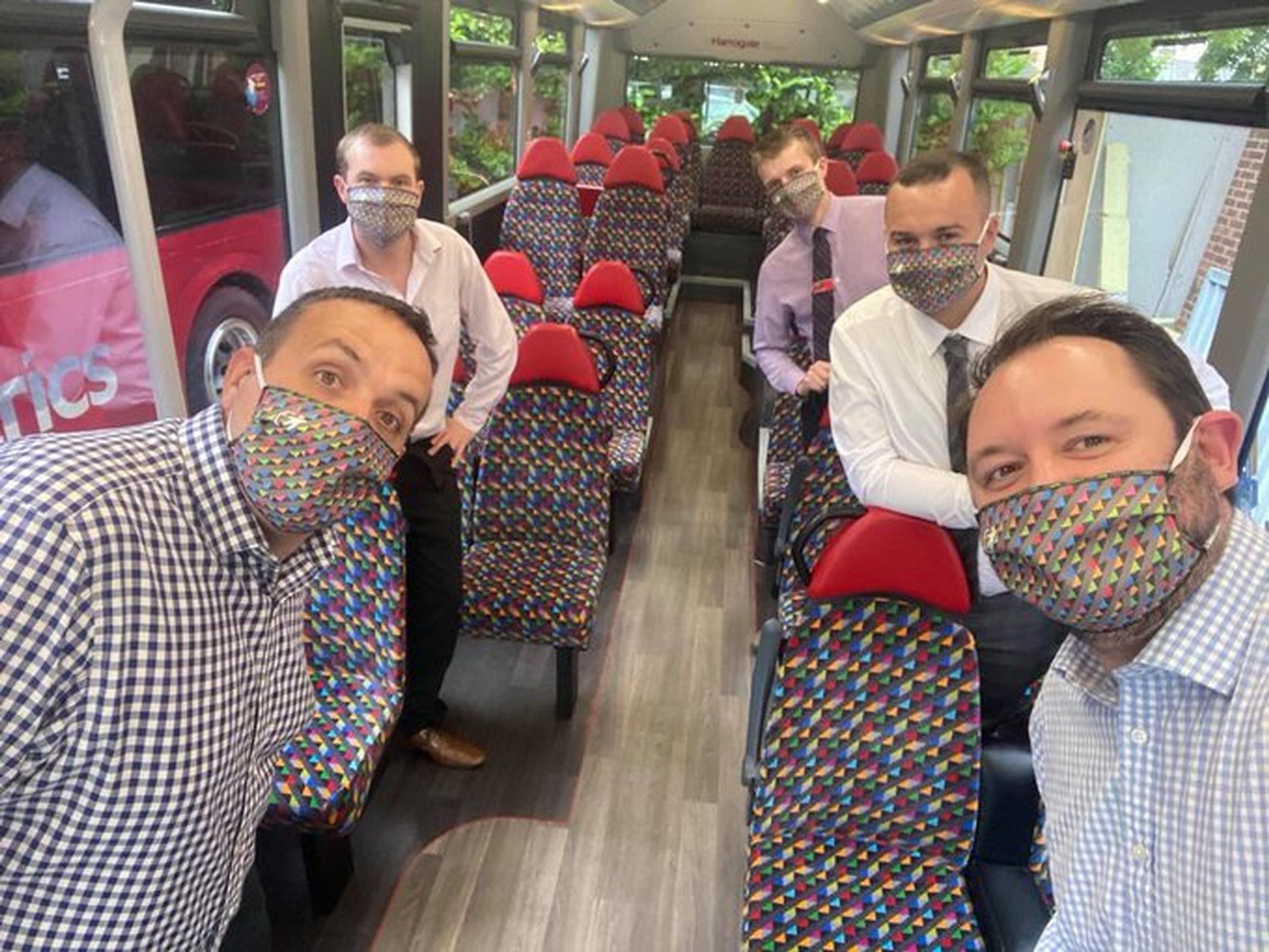 Transdev staff show off their multi-coloured face coverings
