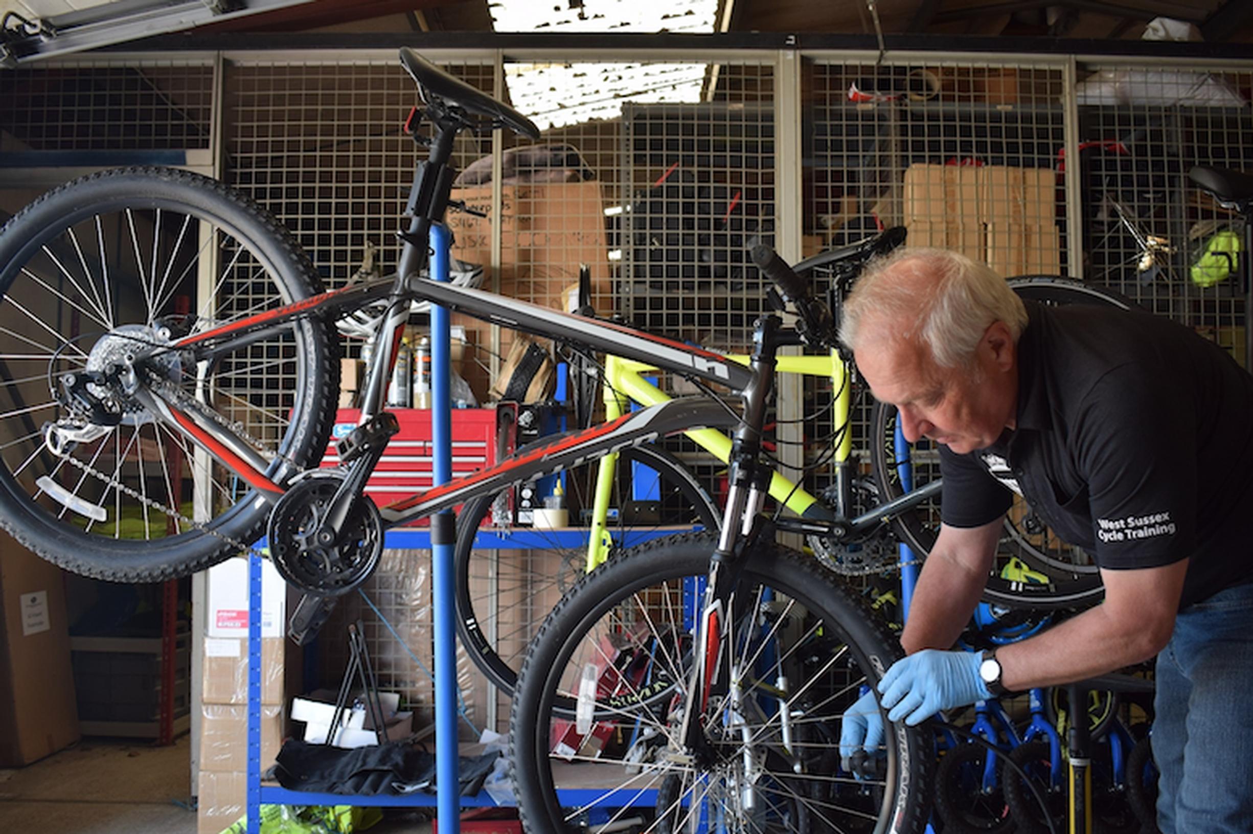 Bikeability instructor Martin Child renovating a bike