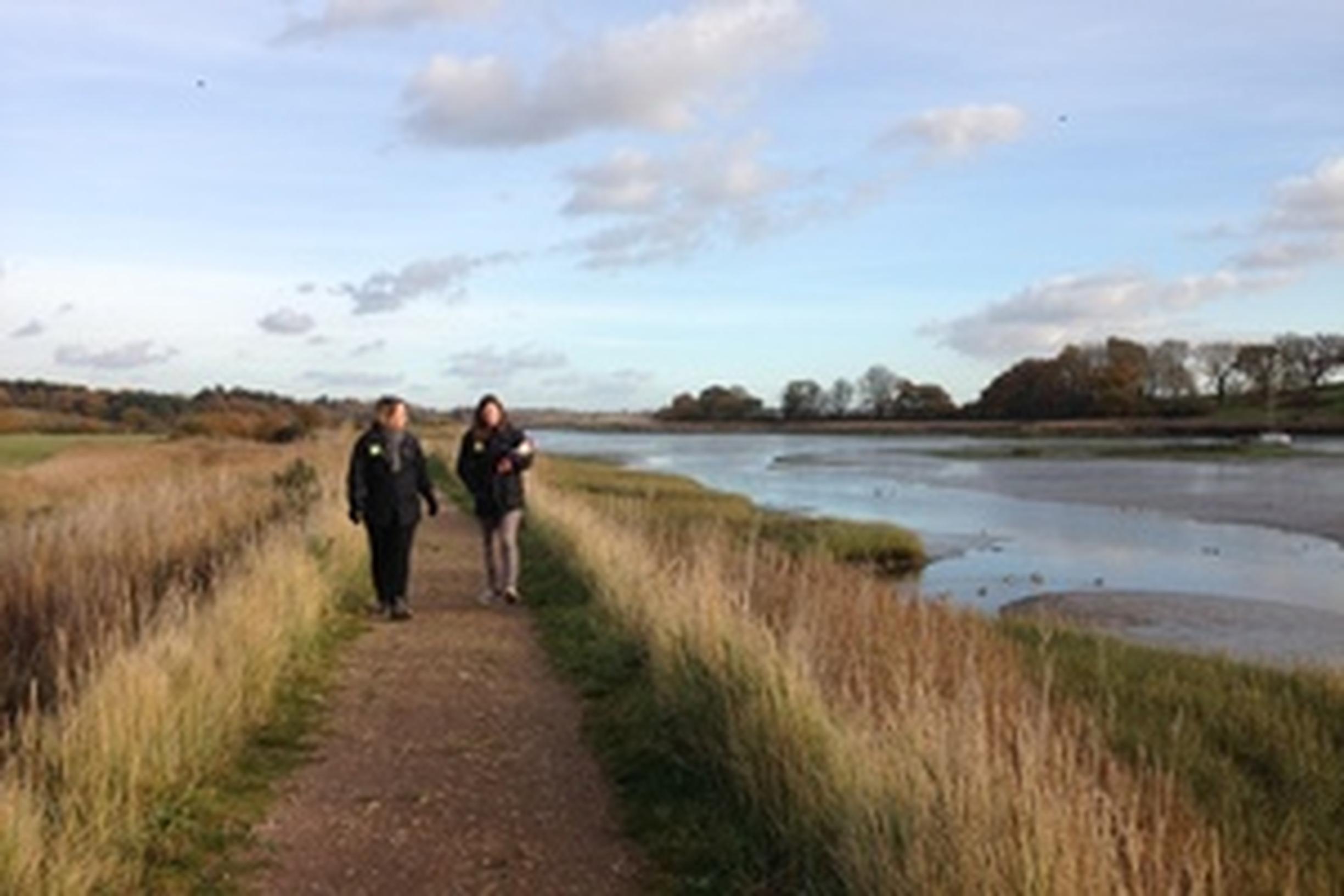 Natural England staff walking beside Martlesham Creek in Suffolk