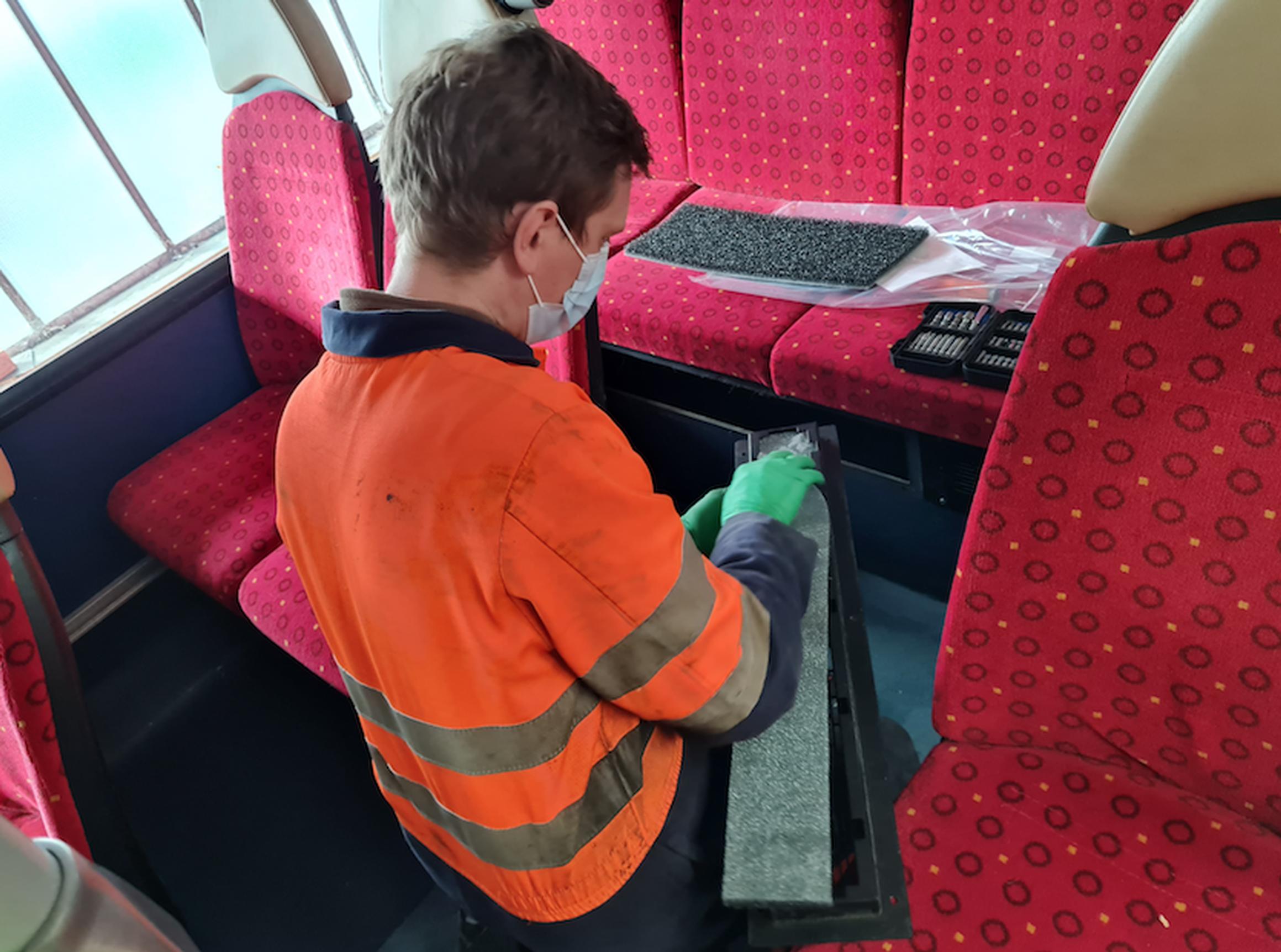 A Brighton & Hove Buses` engineer fits one of the new anti-virus air filters to a bus
