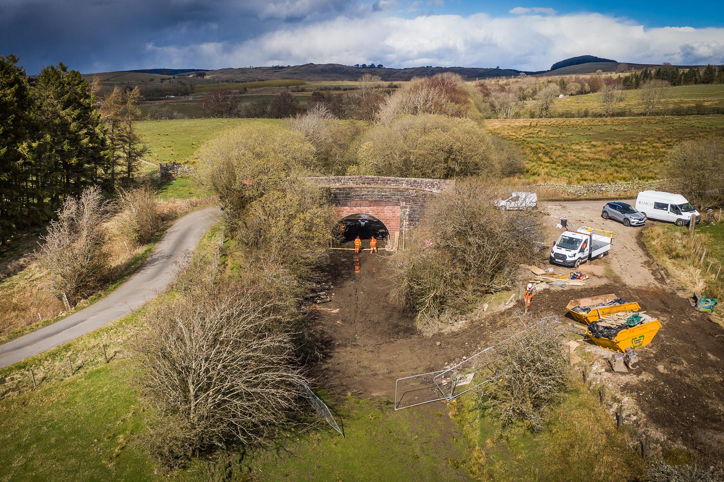 At Troutbeck in Cumbria contractors complete the partial infilling of a bridge on the former Penrith to Keswick railway, which is the subject of a reopening campaign. The installed archway is not sufficiently large for trains to pass through