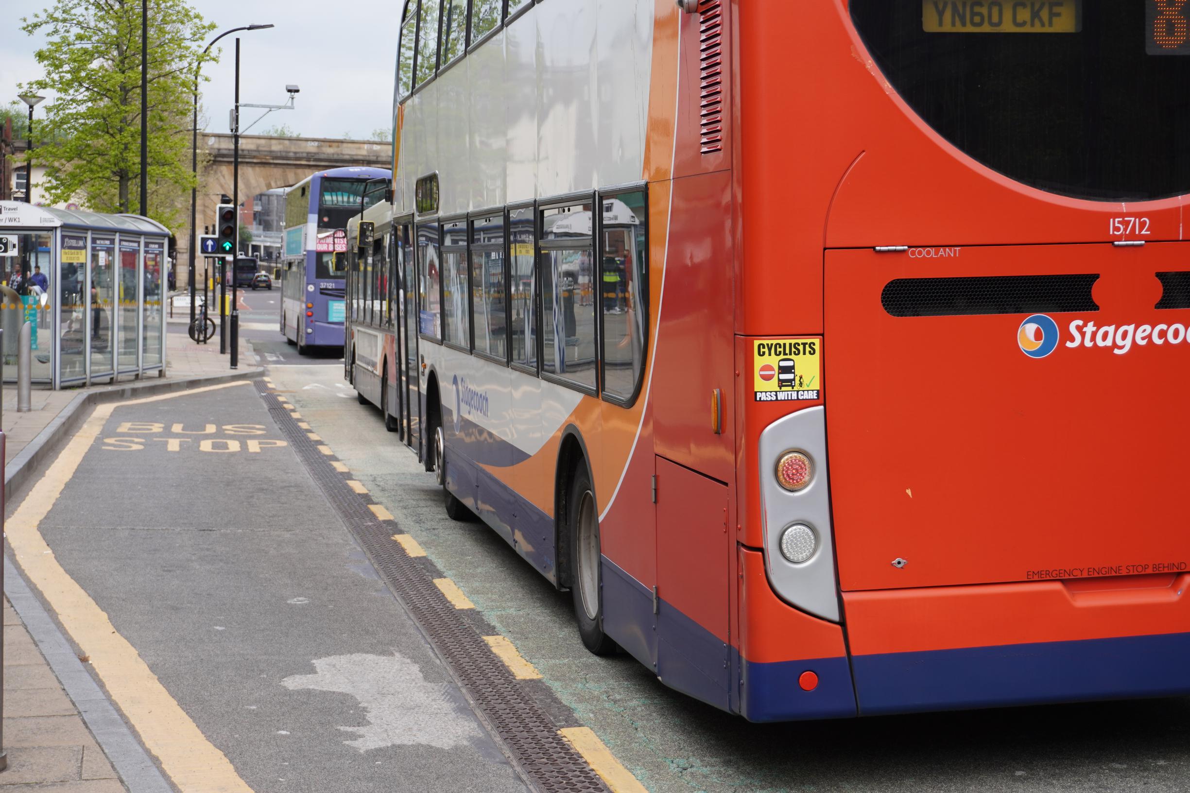Stagecoach and First group buses receiving a green light at a bus priority controlled junction on the Wicker in Sheffield
