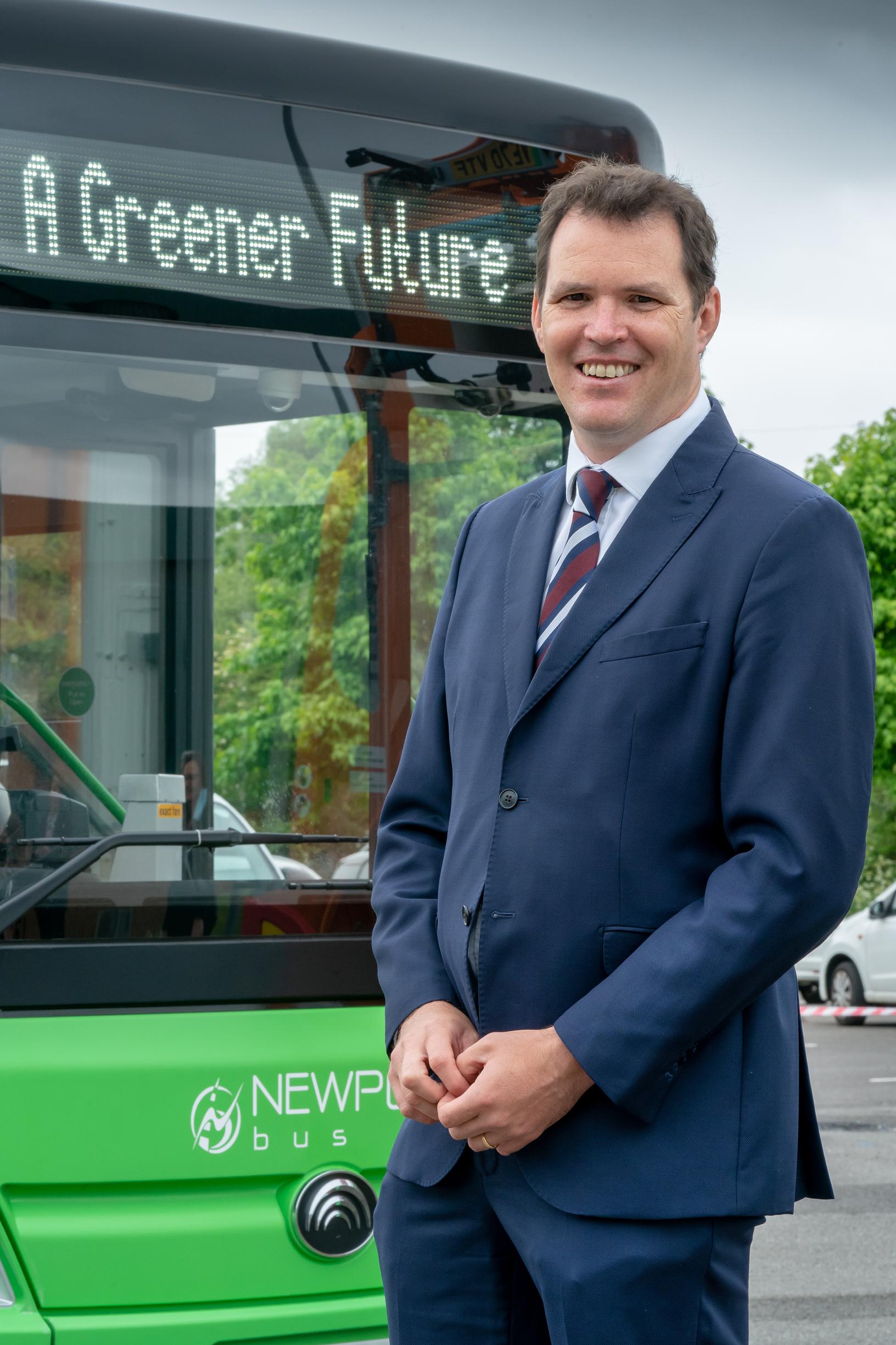 Lee Waters with one of Newport Transport’s electric fleet, the first electric buses in Wales