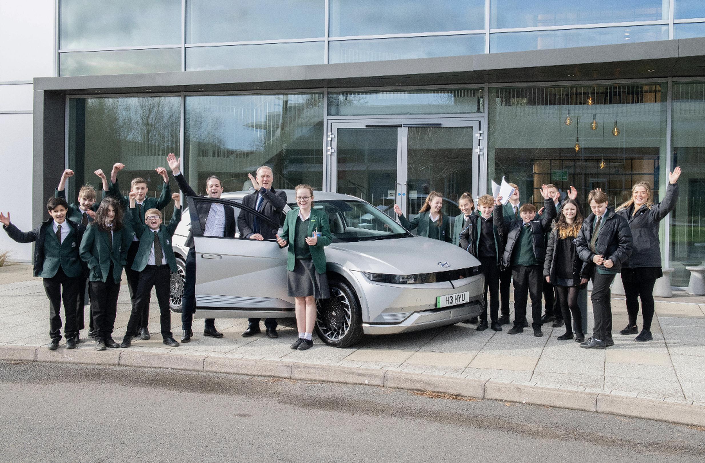 Pupils at Therfield School with a Hyundai IONIQ 5