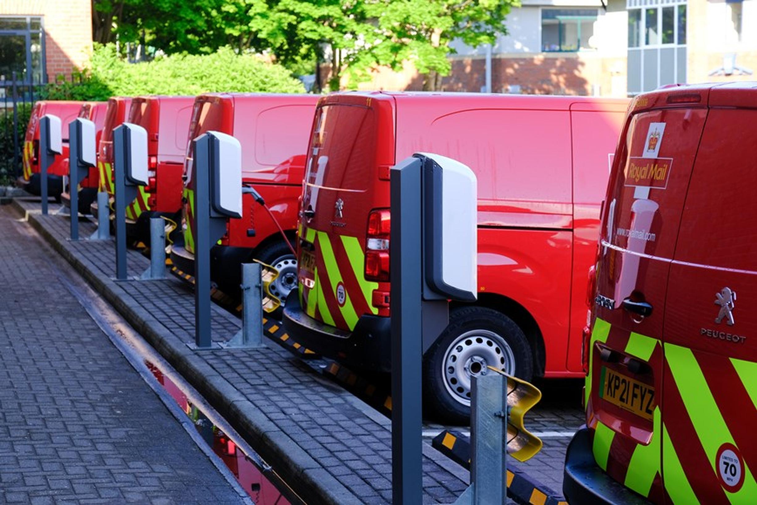 Electric Royal Mail vans re-charge at a depot