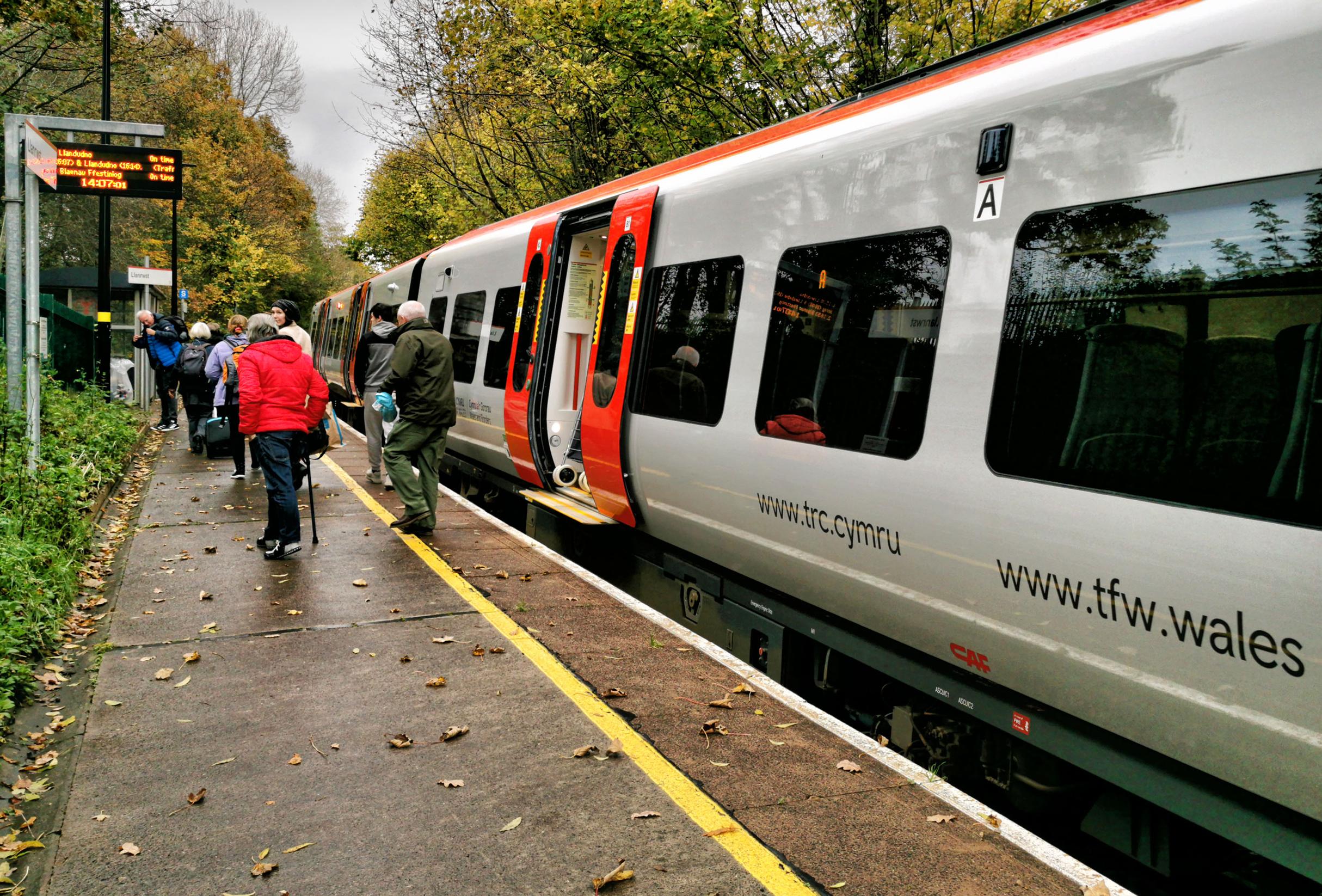 Passengers alight from the first new TfW train at Llanrwst on the inaugural day of Class 197 operation