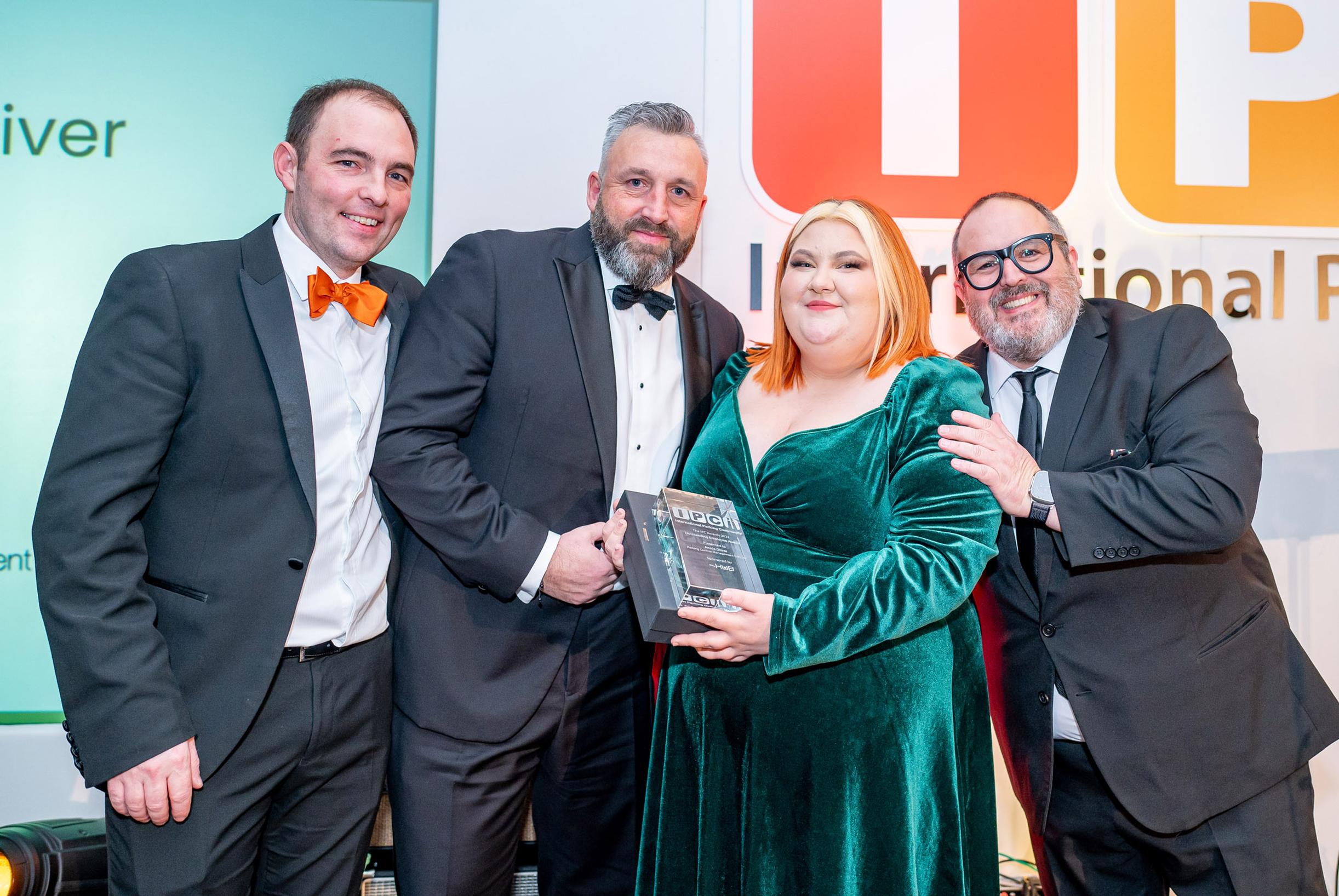 The IPC’s Will Hurley, HUB Parking Technology’s Lee Burton and comedian Justin Moorhouse present Annie Oliver of PCM (UK) with the Outstanding Employee of the Year Award