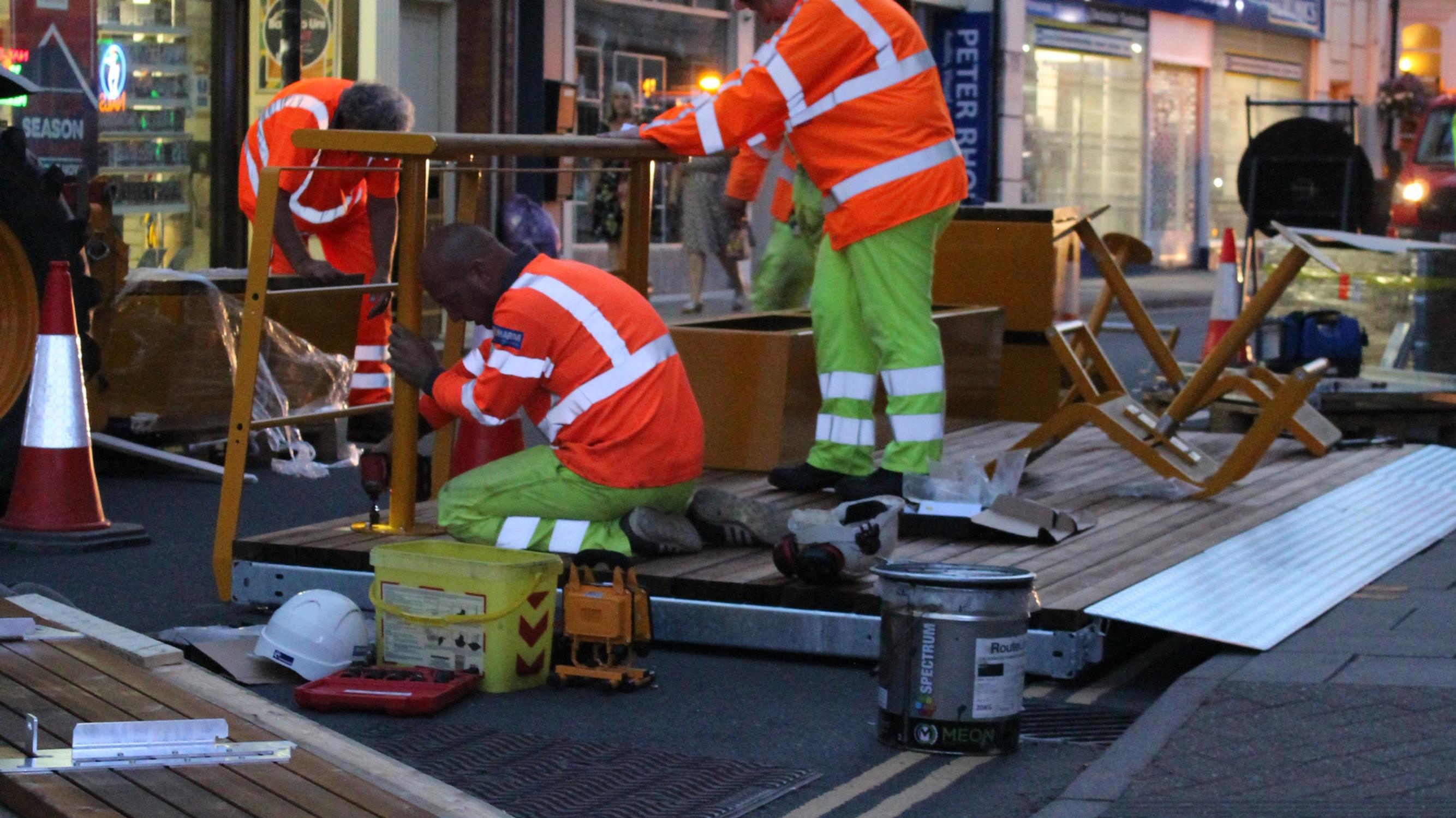 A team removing one of the parklets
