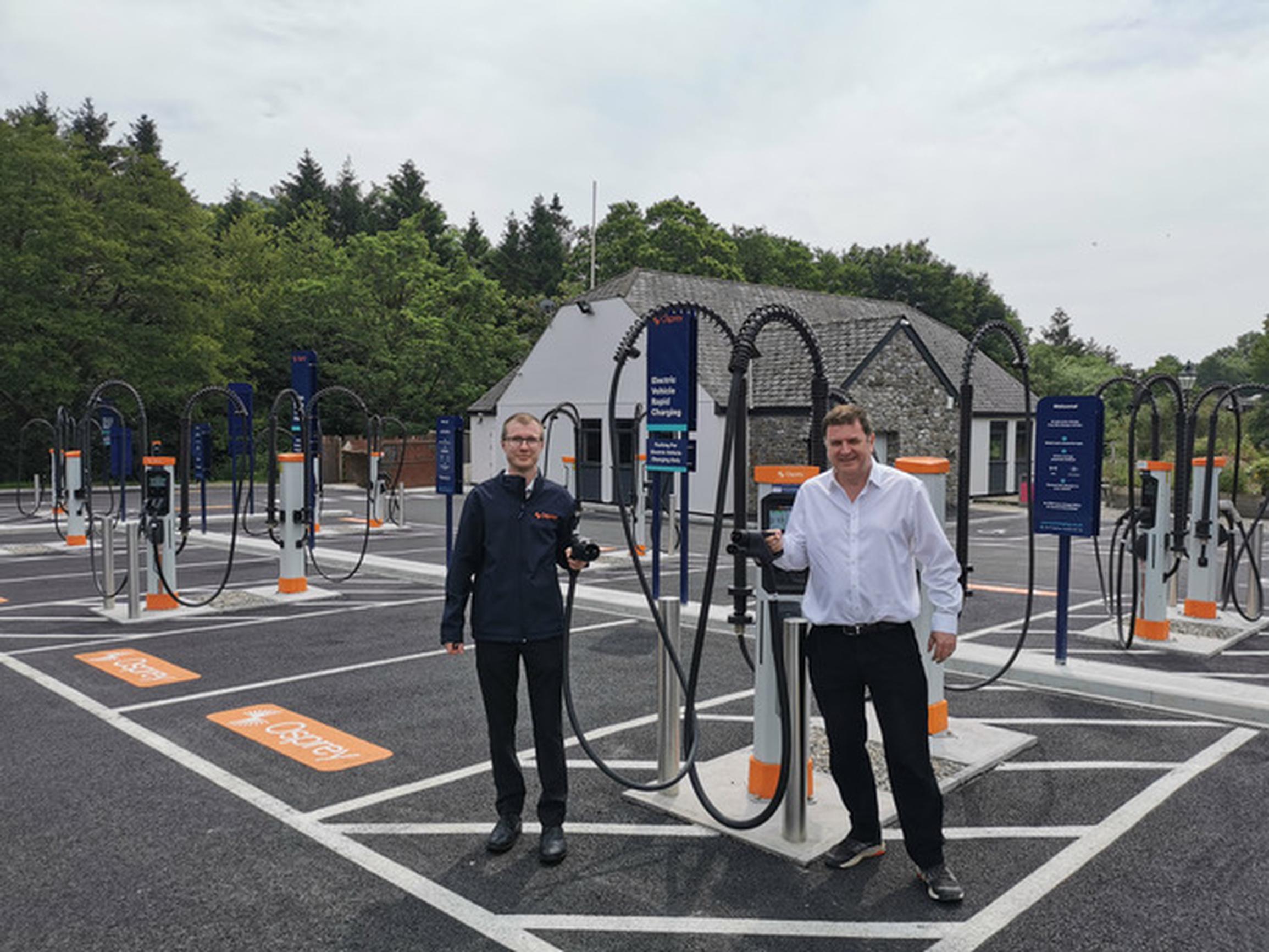 Mark Hall (data and GIS analyst from Osprey Charging) and Mel Stride MP at Osprey’s public EV charging hub at Salmon’s Leap in Buckfastleigh