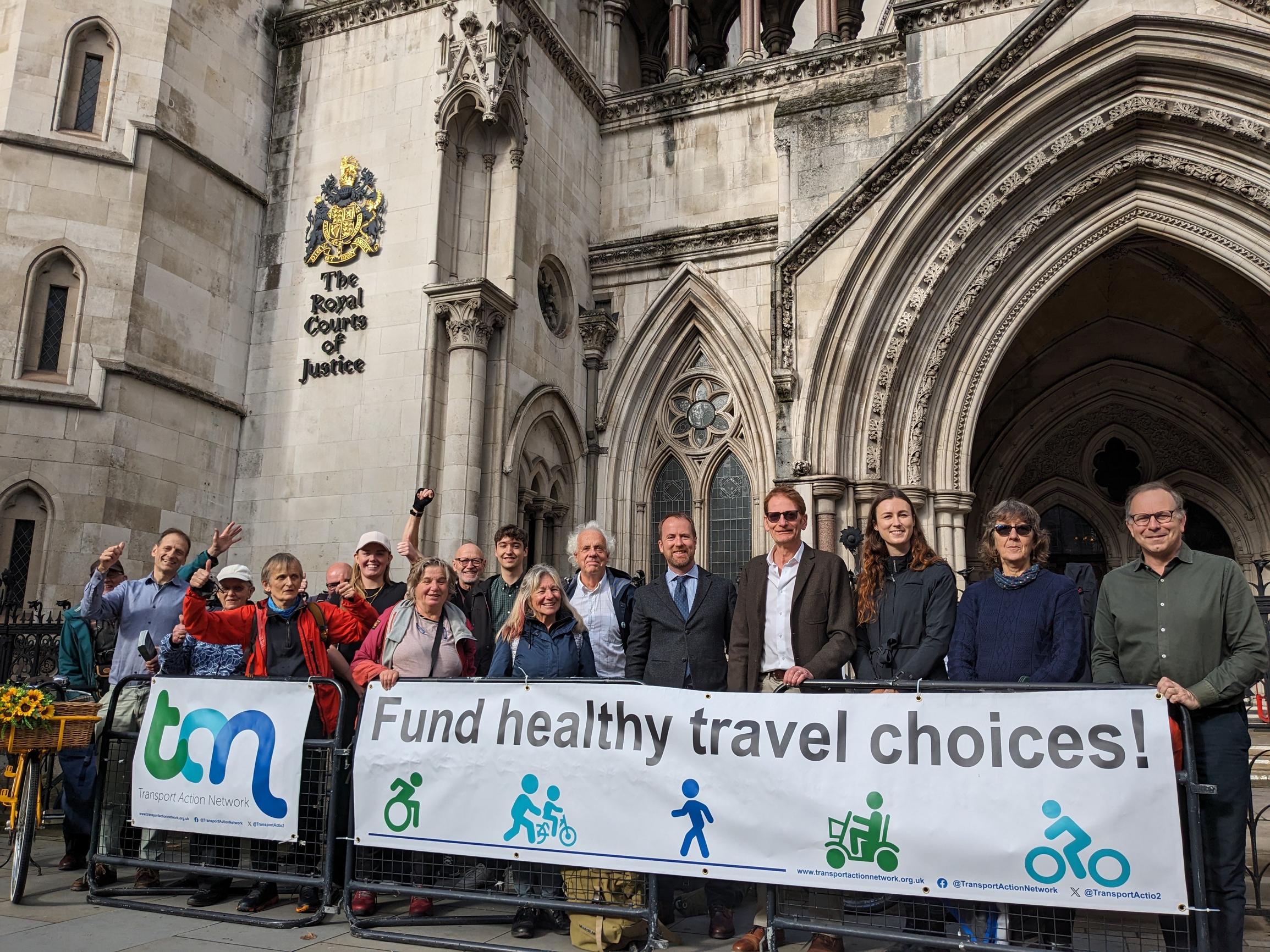 Members of Transport Action Network celebrate at High Court after winning the right to challenge the Government`s decision to cut its walking and cycling budget