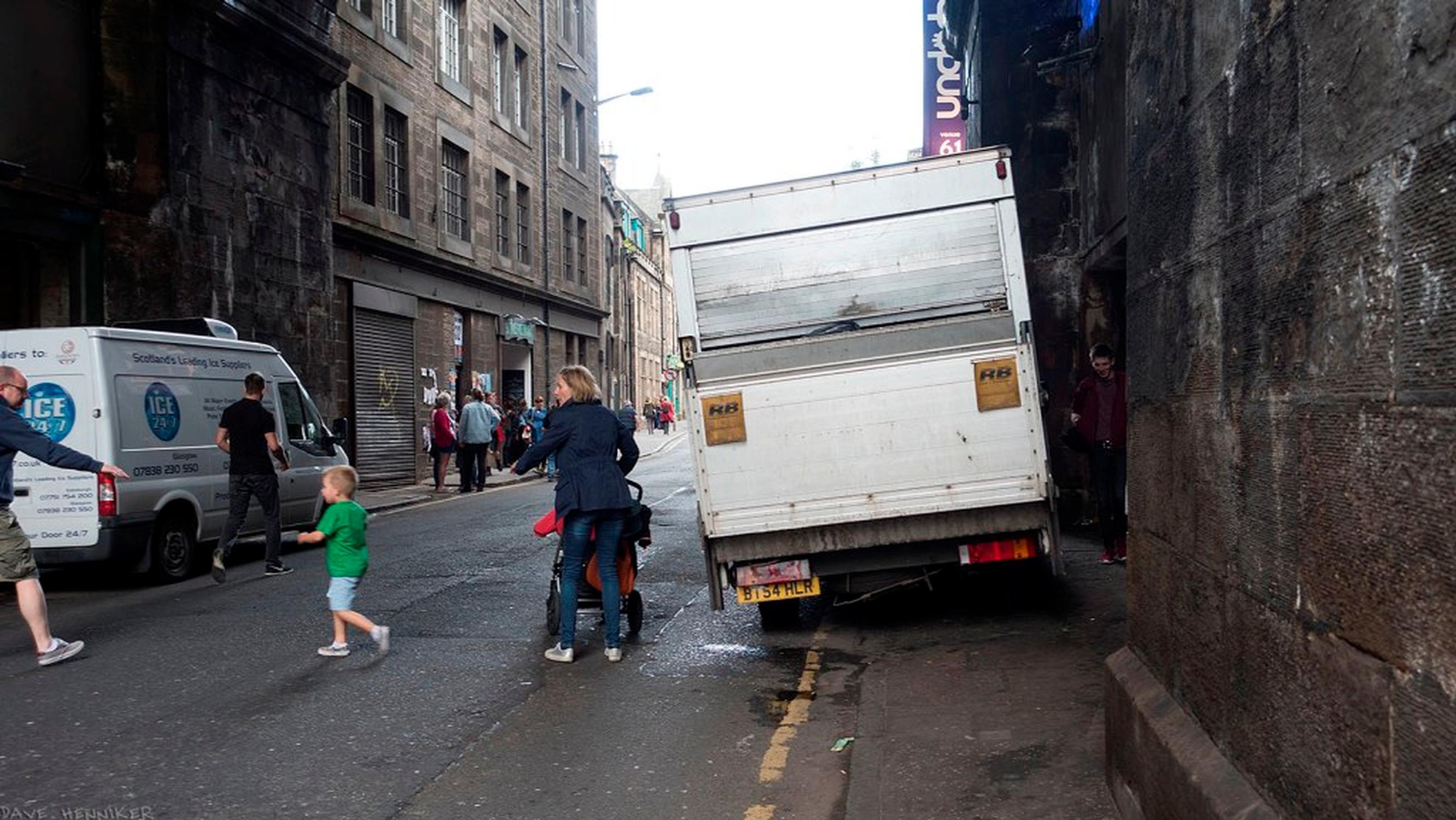 Cars and vans can cause particular challenges for disabled people and parents with pushchairs (Living Streets image of pavement parking in Cowgate, Edinburgh)