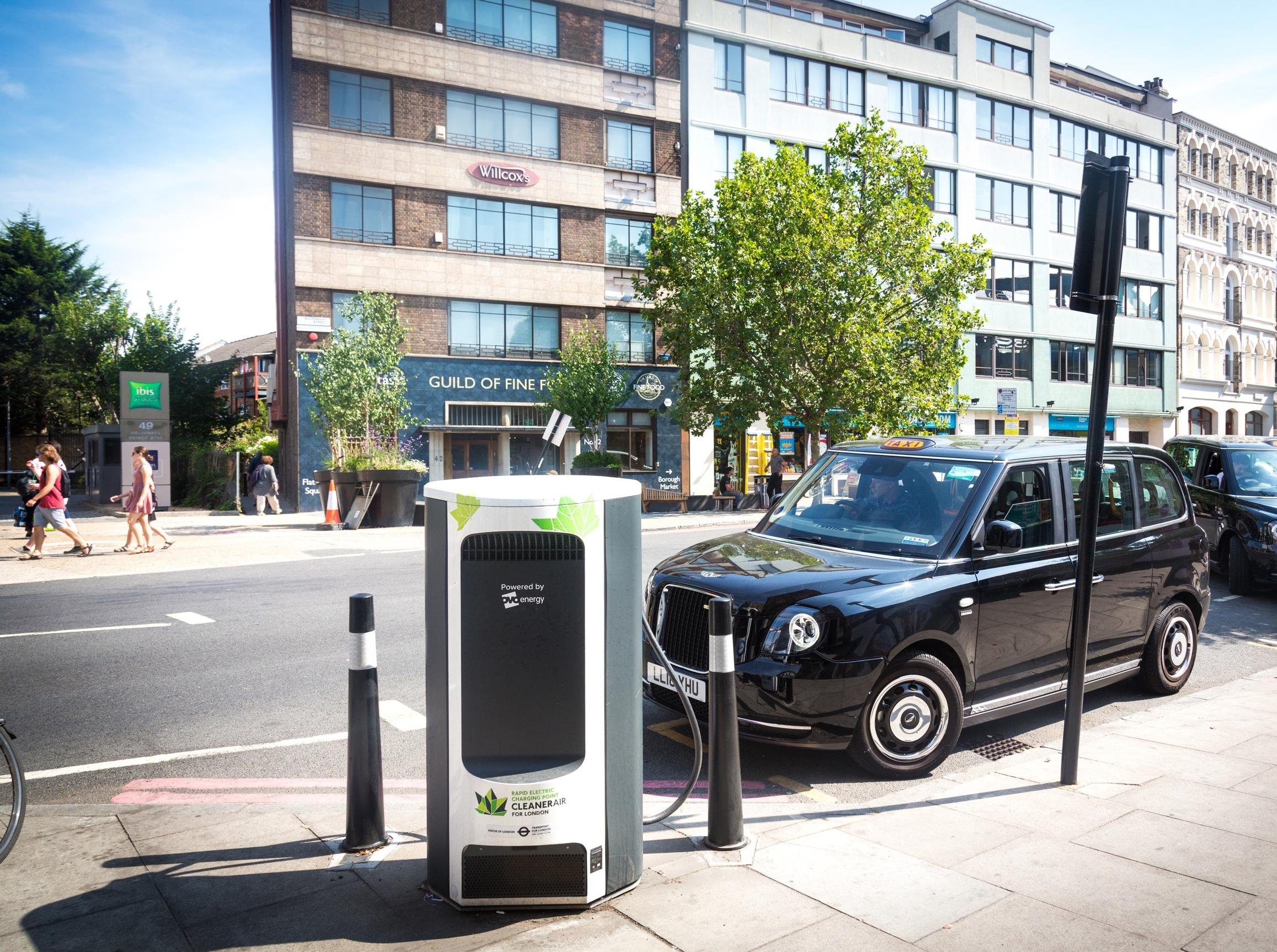 E-taxi rank on Southwark Street with a black taxi parked up along the side of the road next to an electric chargepoint