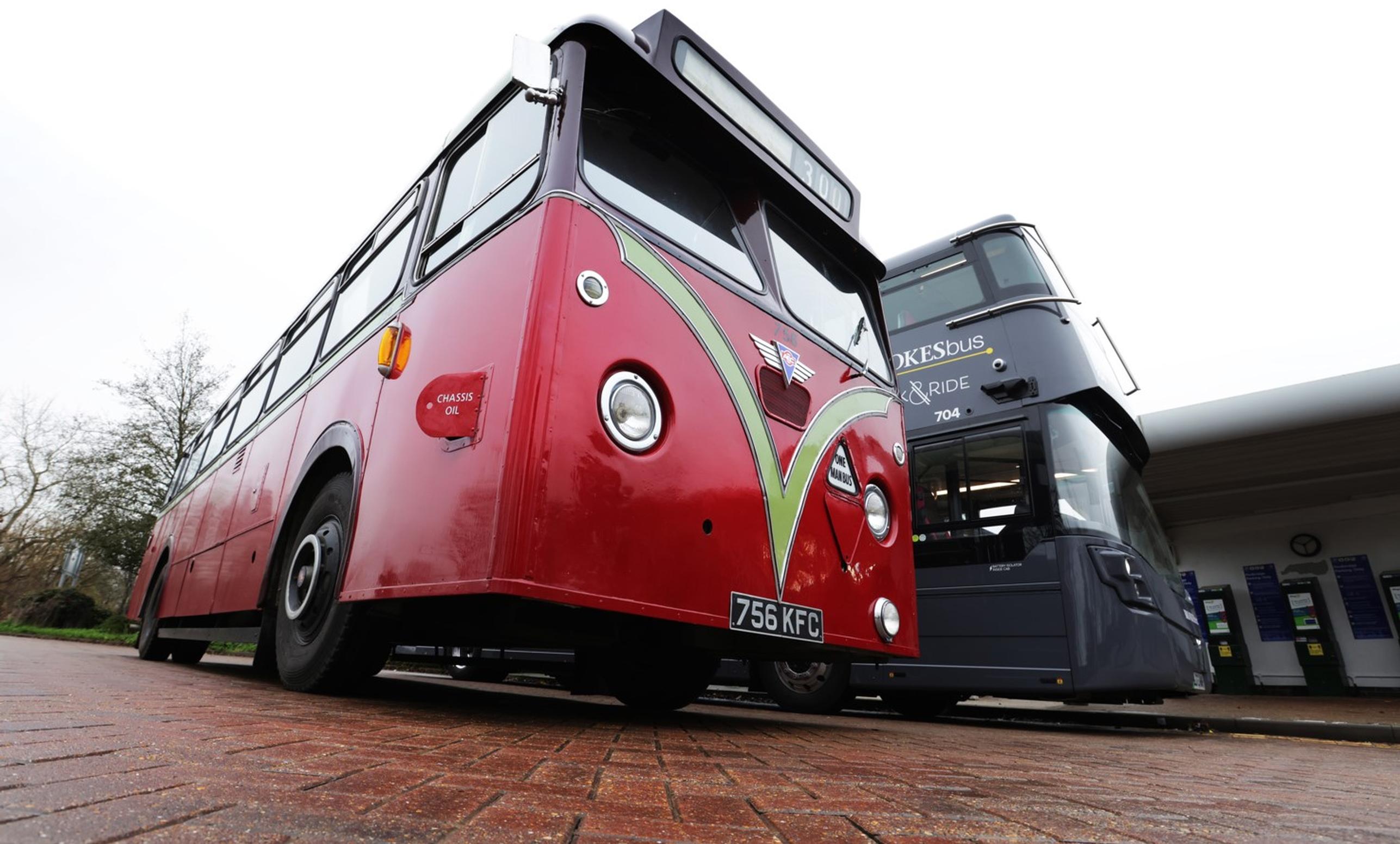 A 1973 vintage bus lines up alongside a new electric bus at Redbridge P&R