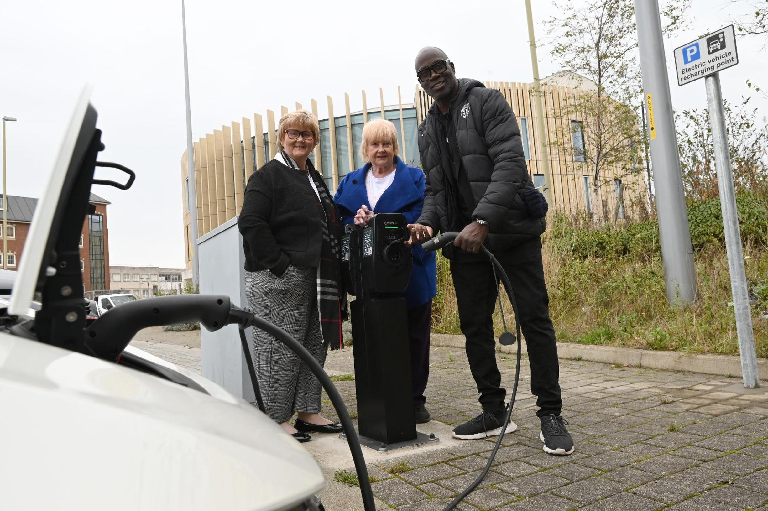 Council leader Cllr Tracey Dixon with Cllr Margaret Meling and Connected Kerb’s brand ambassador Martin Offiah MBE at one of the new charging points at The Word car park, South Shields