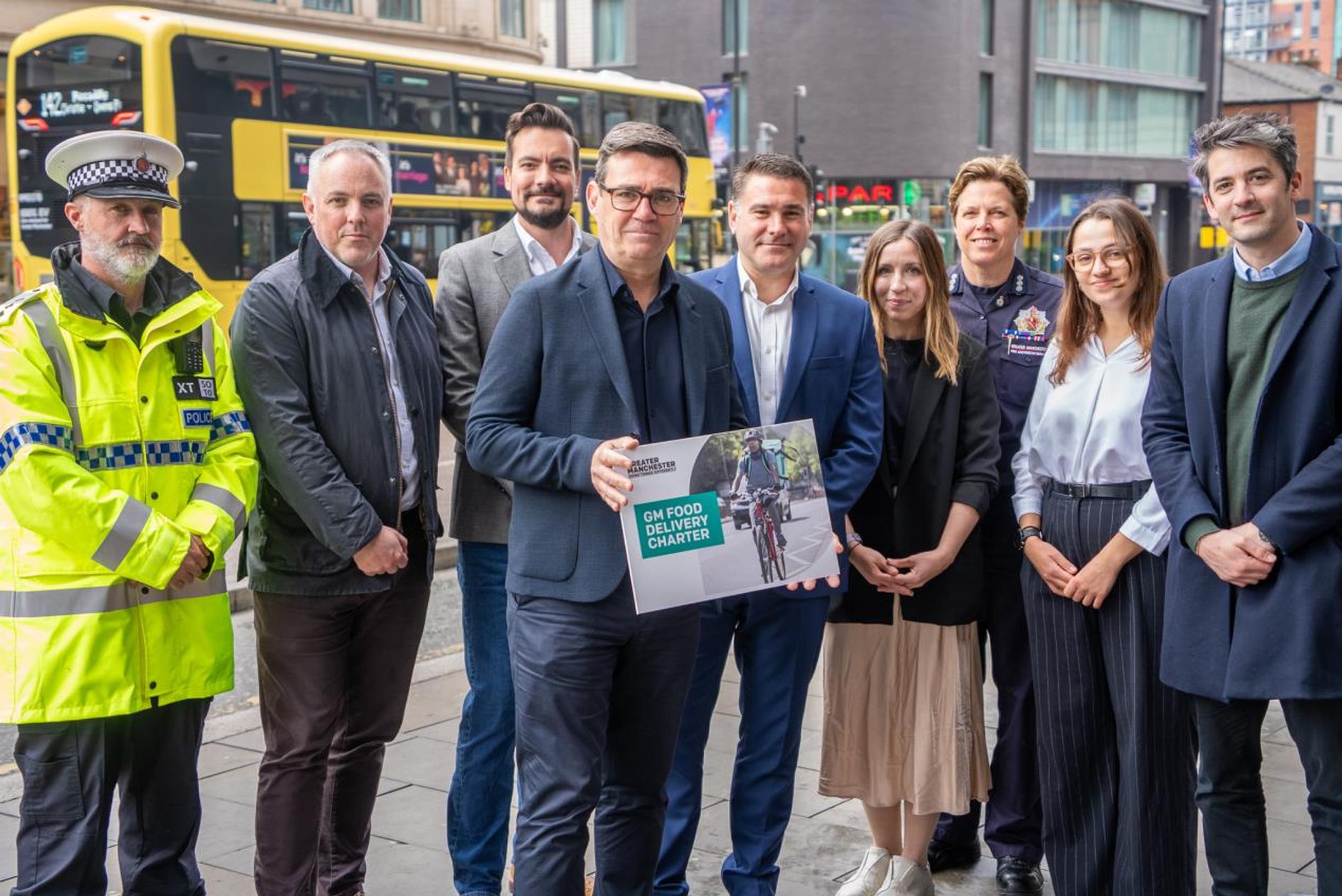 Greater Manchester mayor Andy Burnham (centre) with the new charter to create an industry standard for couriers who use bikes