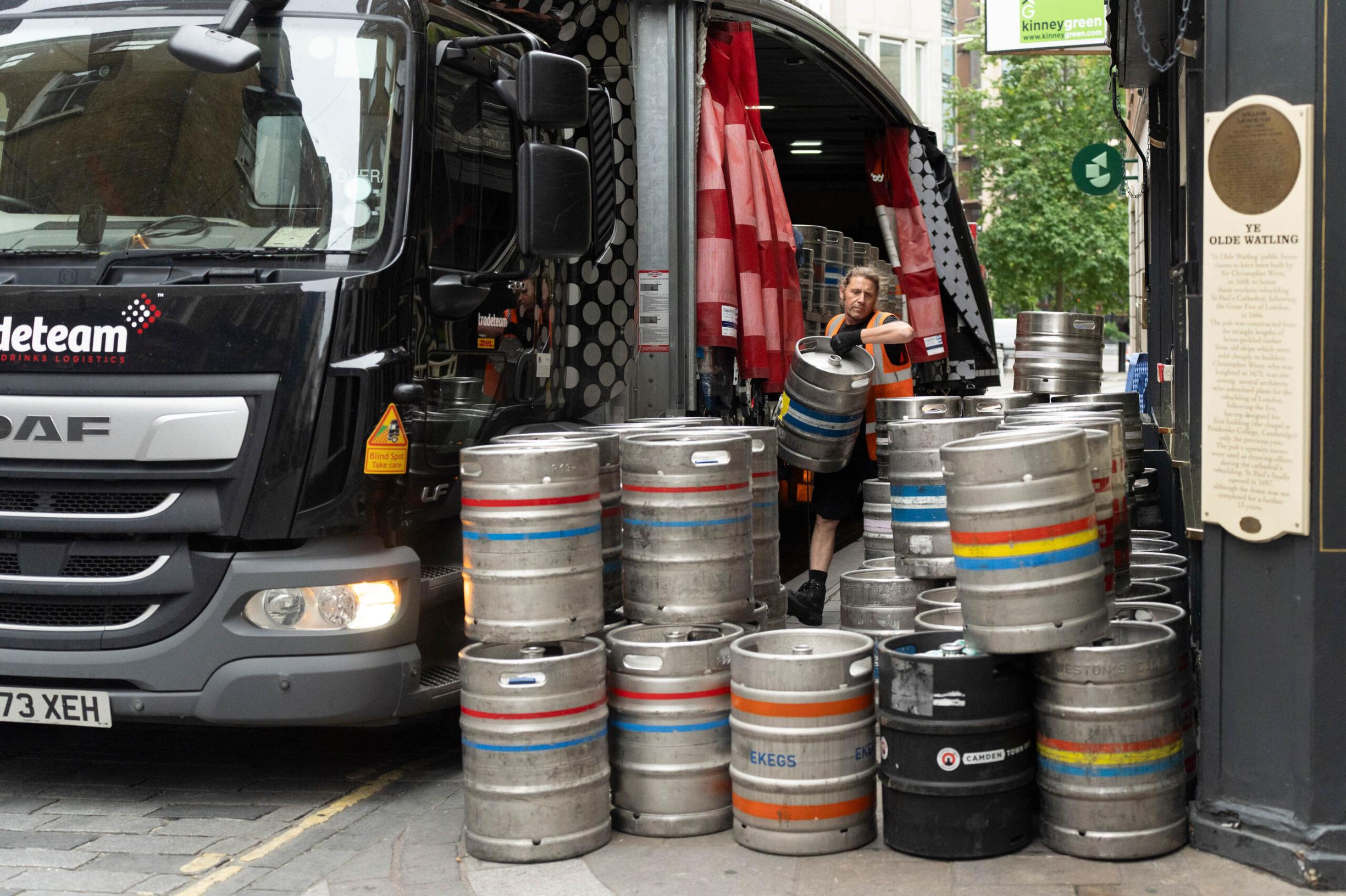 Driver making a delivery of kegs at the Watling Street Virtual Loading Bays in the City of London